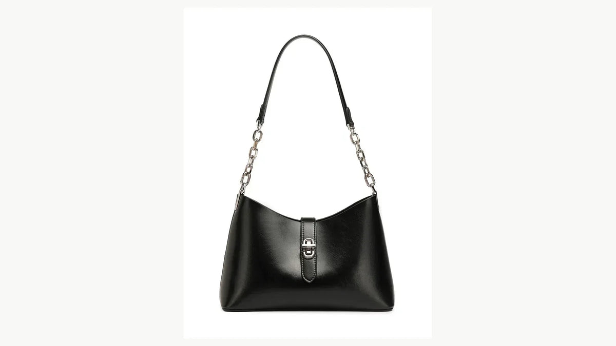 Black leather handbag on a clean white background for a full-grain versus top-grain leather guide