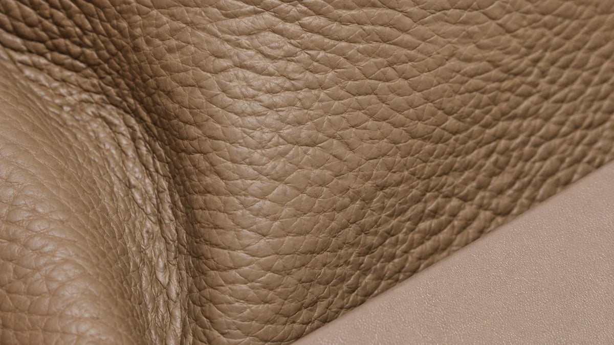 Close-up of taupe pebbled leather beside a flatter diagonal leather panel