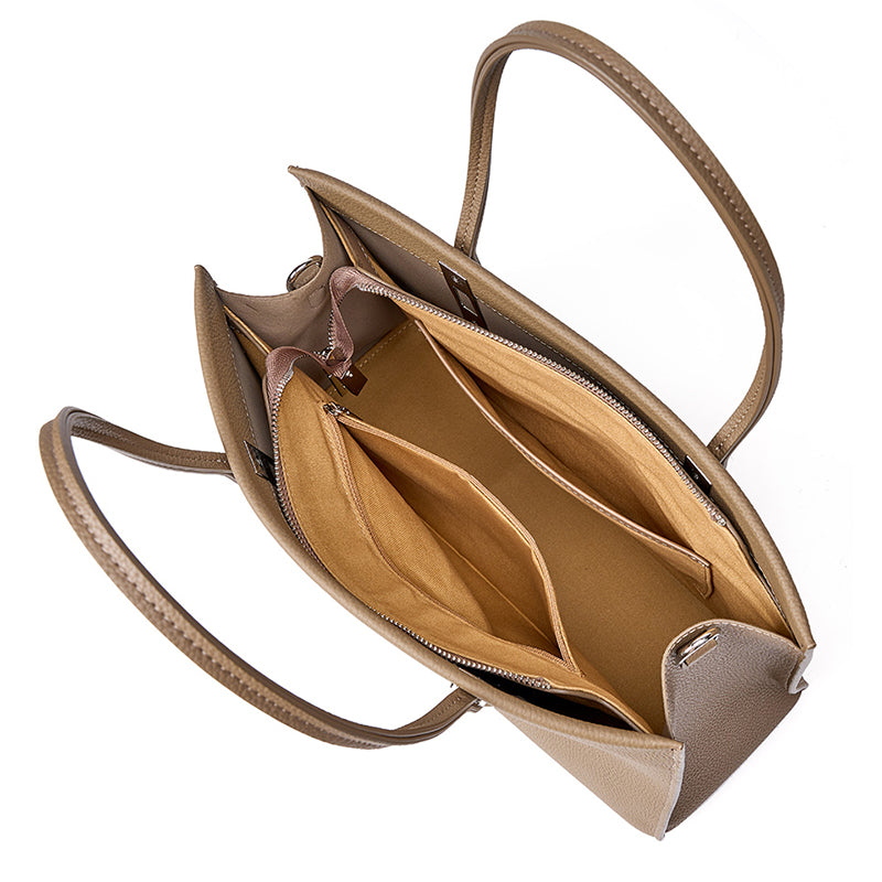 Taupe leather tote opened to show its zippered main compartment and open side sections.