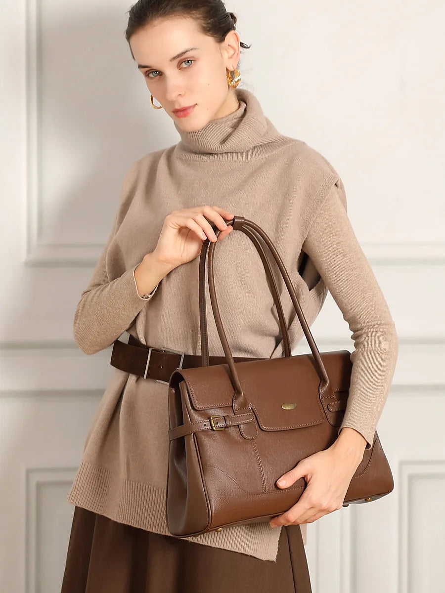 Cuirae brown genuine leather everyday tote bag in warm indoor natural light, lifestyle still life showing smooth leather texture and top handles