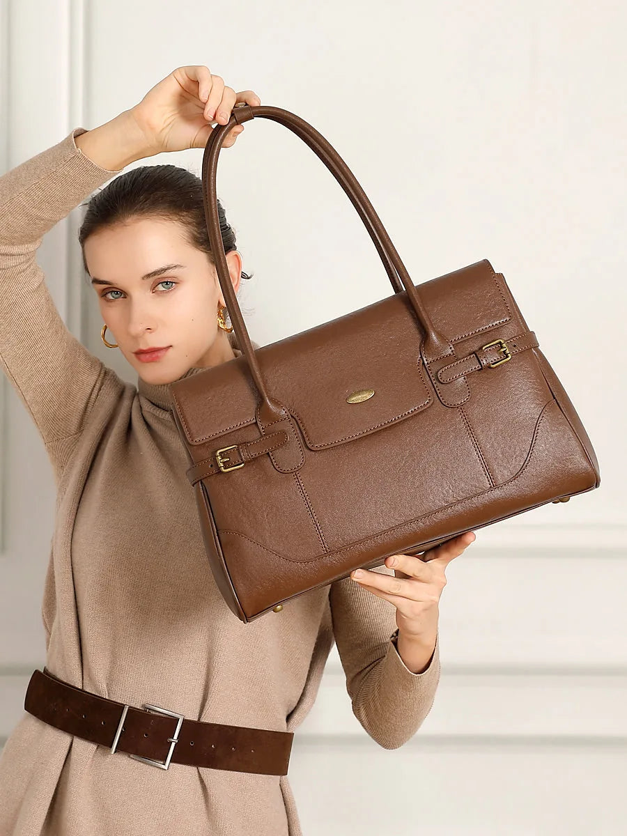 Cuirae chocolate genuine leather everyday tote bag lifestyle shot in warm indoor light, showing rich leather tone and gold hardware