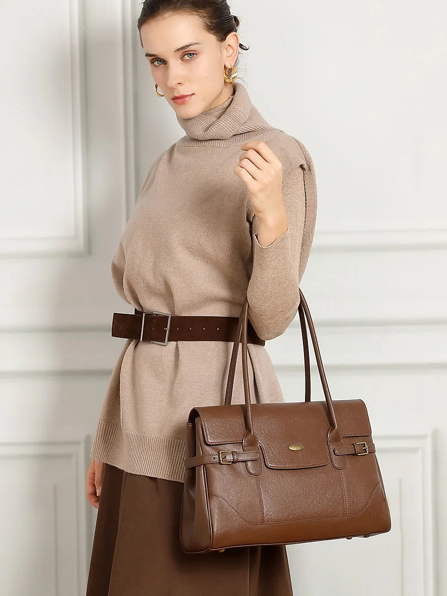Model wearing Cuirae brown genuine leather everyday tote bag on shoulder, lifestyle shot showing real-world size proportion and daily carry style