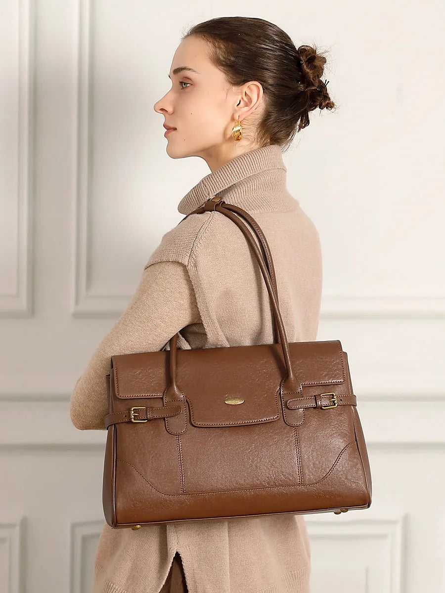 Cuirae chocolate genuine leather everyday tote bag detail closeup showing gold hardware, reinforced top handles, and smooth leather texture