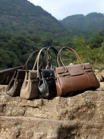 Cuirae black top-grain leather everyday tote bag with top handles and gold hardware, front view on white background