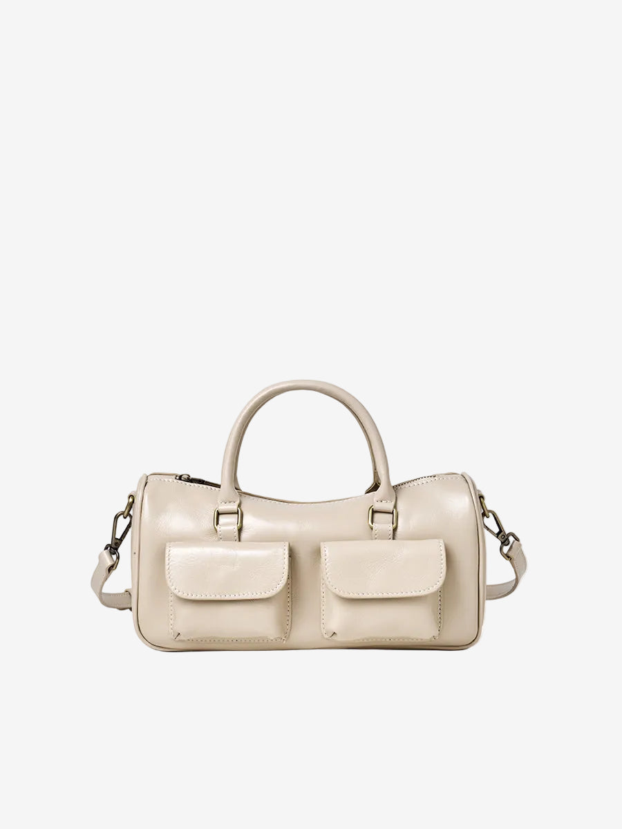Cuirae off beige genuine leather bowling crossbody bag with double pockets, front view showing smooth leather texture
