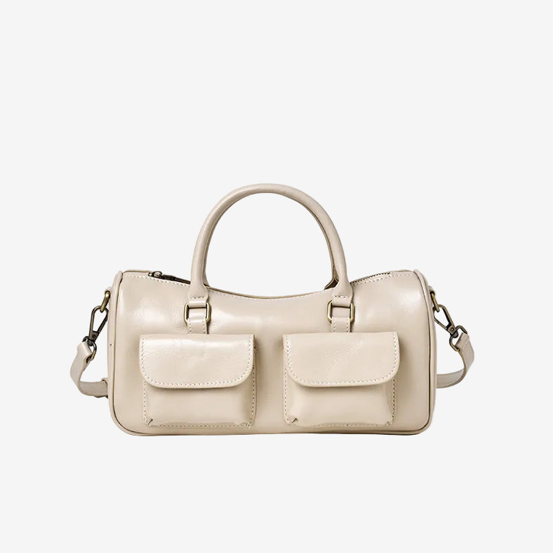 Cuirae off white genuine leather bowling crossbody bag with double pockets, front view showing smooth leather texture
