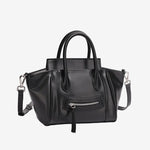 A front view of the Cuirae black top grain cowhide handbag with a front zipper pocket, sitting on a plain white background.