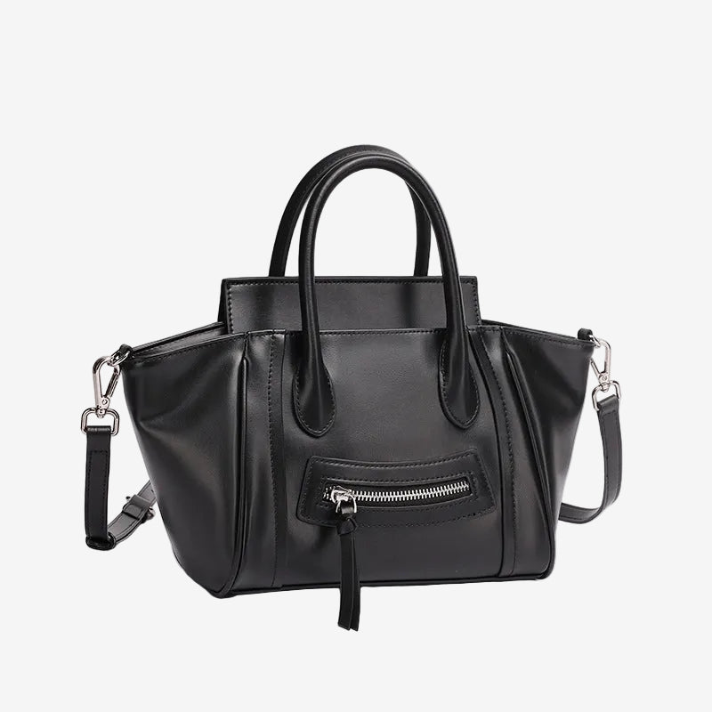 A front view of the Cuirae black top grain cowhide handbag with a front zipper pocket, sitting on a plain white background.