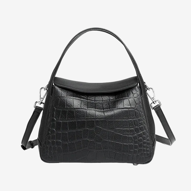 Cuirae black crocodile embossed genuine leather crossbody bag with flap design and detachable strap, front view on white background
