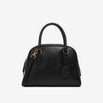 Cuirae  black genuine leather dome handbag with detachable shoulder strap and tag charm, front view on white background