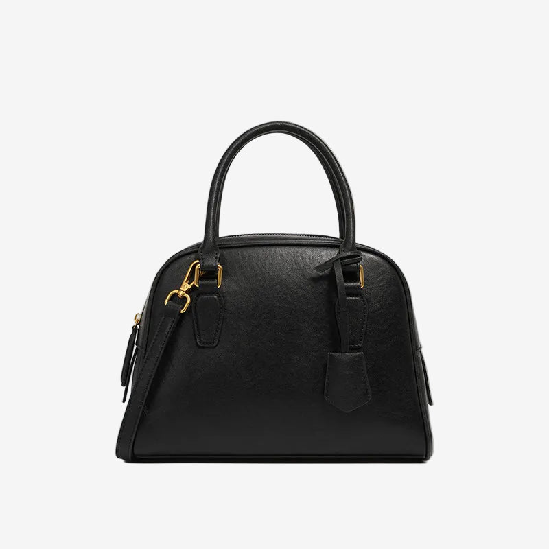 Cuirae  black genuine leather dome handbag with detachable shoulder strap and tag charm, front view on white background
