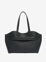 Cuirae black genuine leather tote bag, back view showing exterior zip pocket and luggage sleeve