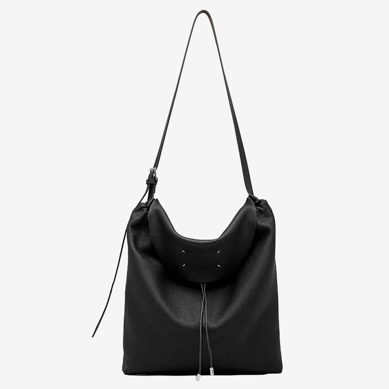 A front view of the Cuirae black genuine leather tote bag standing on a plain background.