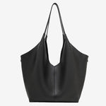 A front view of the Cuirae black genuine leather tote bag standing on a plain background.