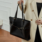 Cuirae black genuine leather tote bag for women with gold buckle belt detail, handheld front view