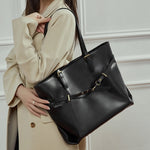Cuirae black genuine leather work tote bag with gold hardware, worn on shoulder front view
