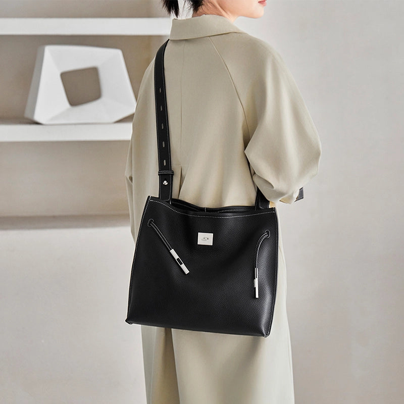 Cuirae black genuine leather tote bag for women with silver hardware, worn on shoulder back view