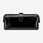 Cuirae black glossy genuine leather makeup bag with buckle closure, front view on white background