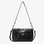Cuirae black glossy genuine leather crossbody bag with turnlock detail and adjustable strap, front view on white background