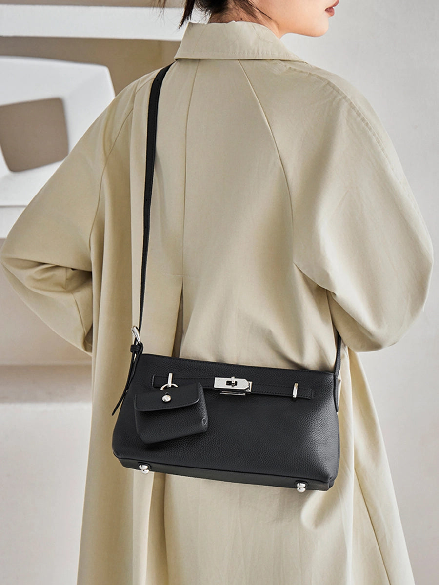 Model wearing Cuirae black leather crossbody bag with coin purse crossbody, back view showing adjustable strap and hardware