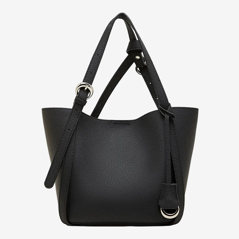 Cuirae black pebbled genuine leather bucket bag with adjustable strap and silver hardware, front view on white background