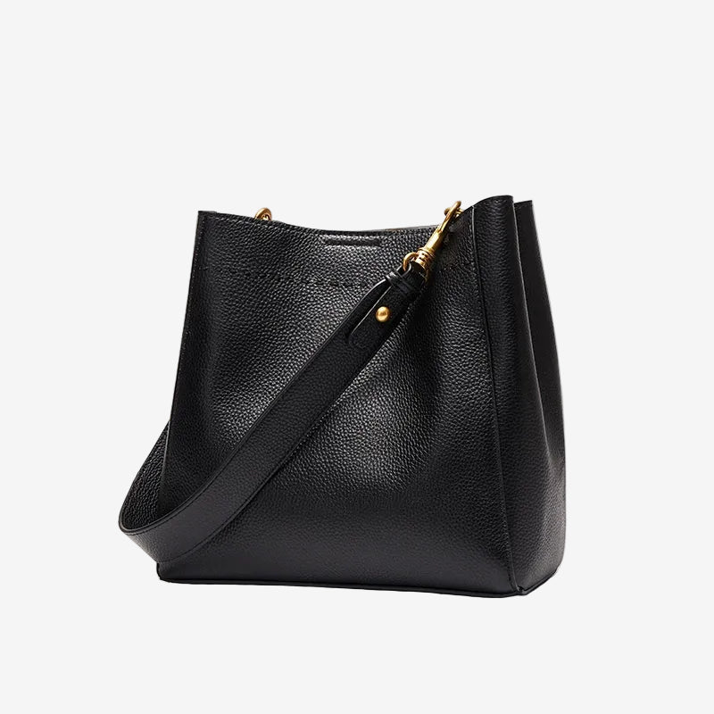 Cuirae black pebbled genuine leather bucket bag with gold hardware, front view on white background