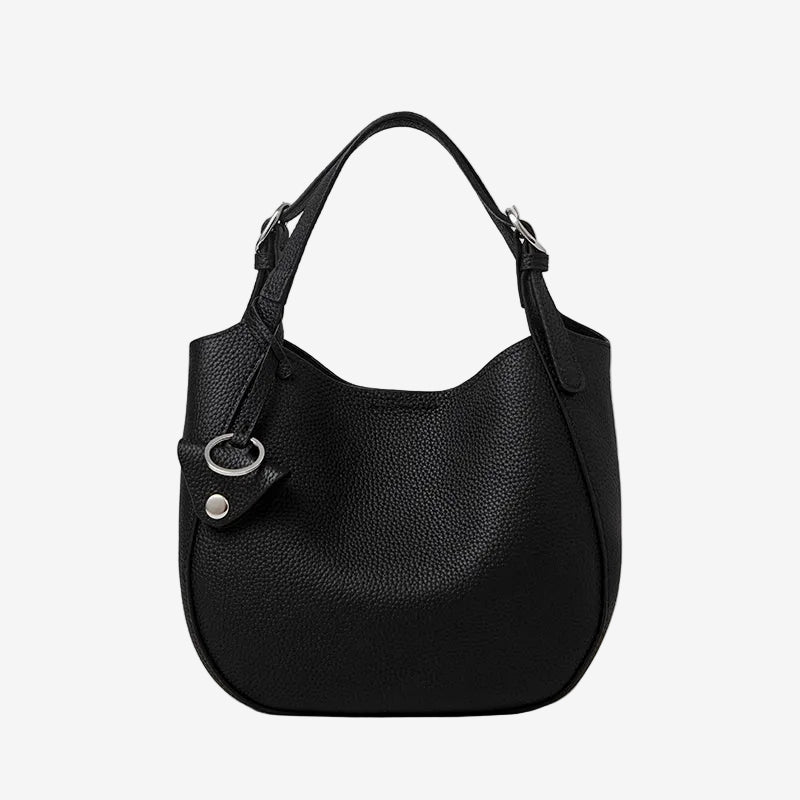 Cuirae black pebbled genuine leather bucket bag with silver hardware and top handle, front view on white background