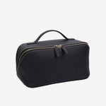 Cuirae black pebbled genuine leather makeup bag with top handle and gold zipper, front angled view on white background