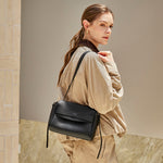 Model wearing the Cuirae black pebbled leather flap shoulder bag