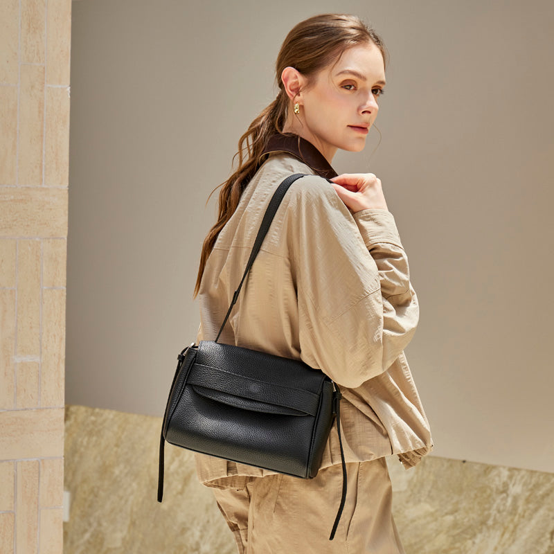 Model wearing the Cuirae black pebbled leather flap shoulder bag