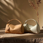 Cuirae bronze and stone genuine leather bowling bags side by side, showing available color options for women