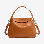 Cuirae brown crocodile embossed genuine leather crossbody bag with flap design and detachable strap, front view on white background