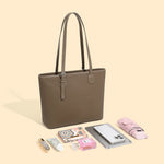 The Cuirae brown genuine leather tote bag with various items 