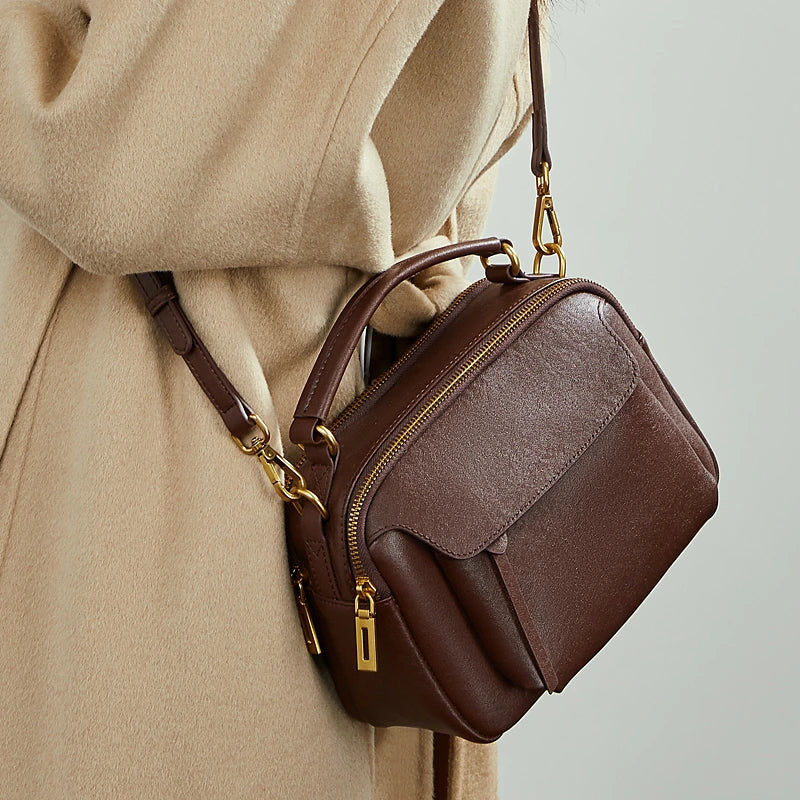 Cuirae brown genuine leather  bag on shoulder, angled view highlighting detachable crossbody strap