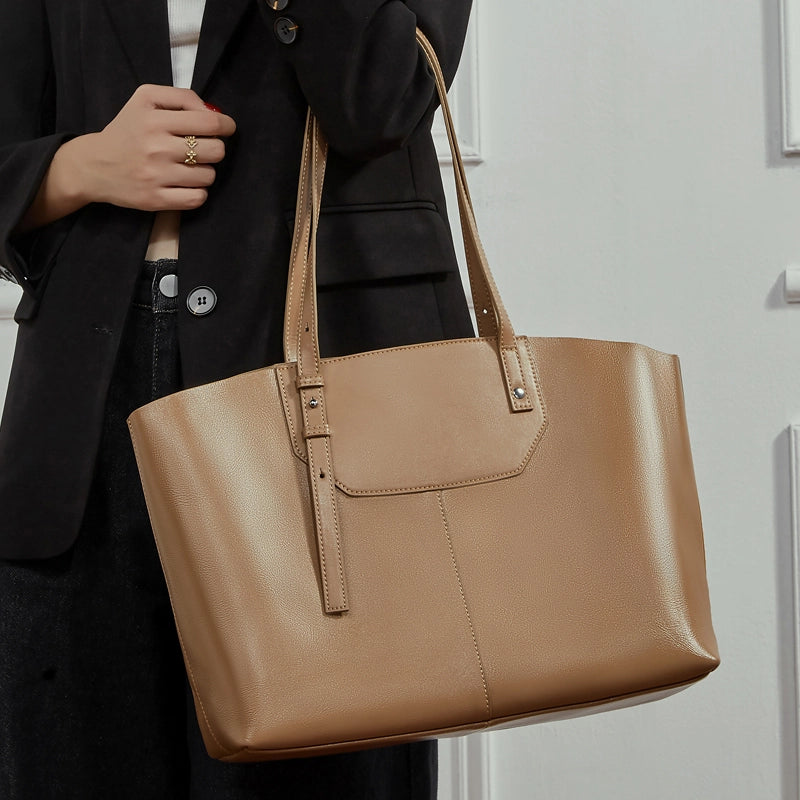 A model is carrying a brown genuine leather Cuirae bag.