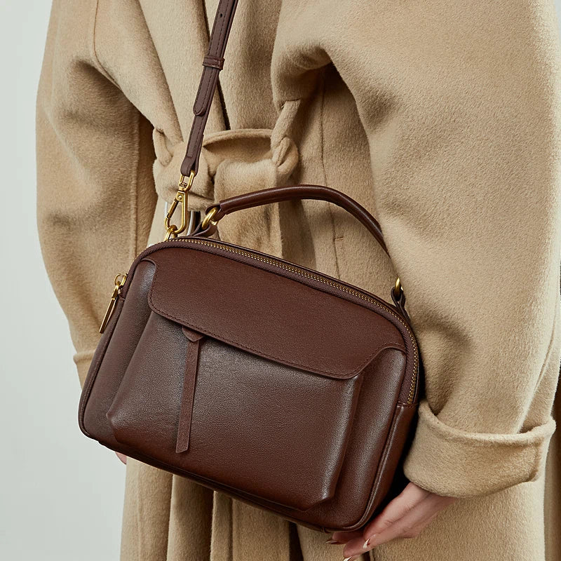 Cuirae brown genuine leather mini shoulder bag worn on shoulder, back view showing soft leather texture