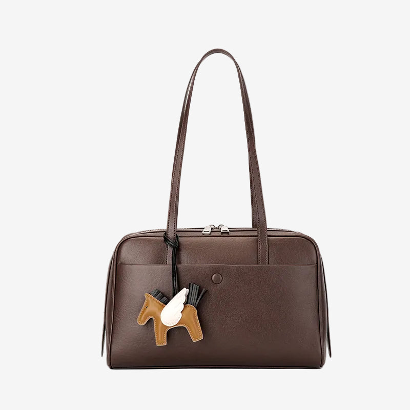 Cuirae brown genuine leather shoulder bag with pony charm and exterior pocket, front view on white background