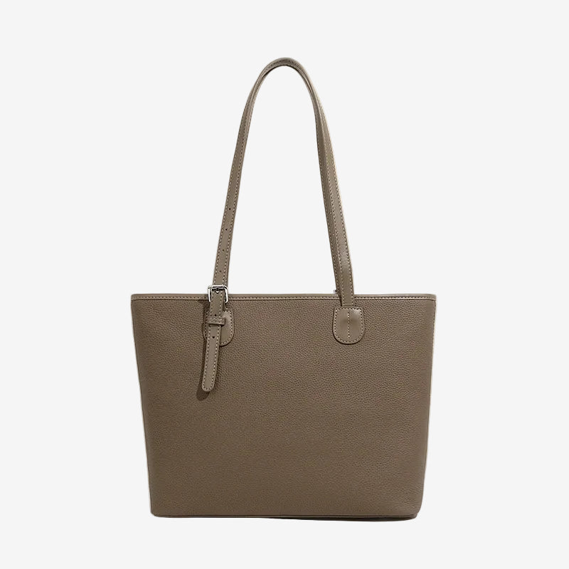 A front view of the Cuirae brown genuine leather tote bag standing on a plain background.
