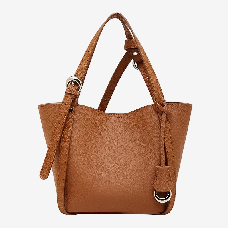 Cuirae brown pebbled genuine leather bucket bag with adjustable strap and silver hardware, front view on white background