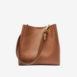 Cuirae brown pebbled genuine leather bucket bag with gold hardware, front view on white background
