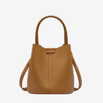Cuirae brown pebbled genuine leather bucket bag with top handle and detachable strap, front view on white background