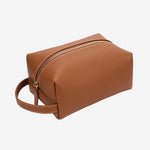 Cuirae brown pebbled genuine leather makeup bag with gold zipper and wrist strap, front angled view on white background