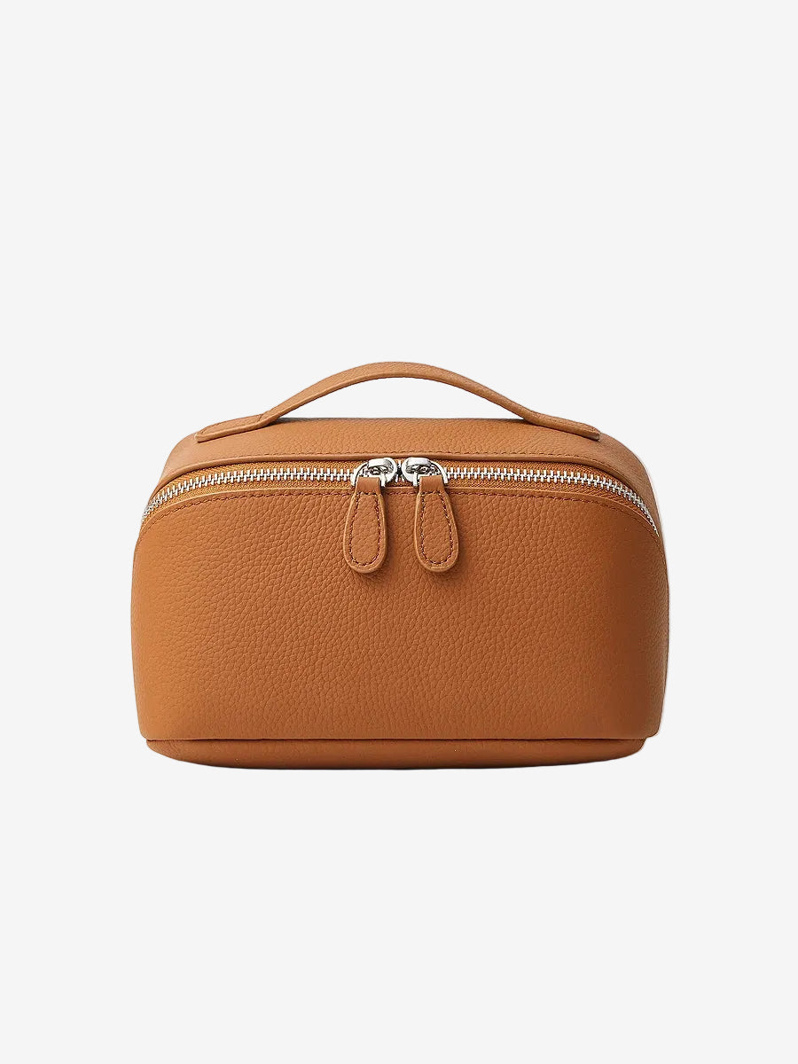 Cuirae brown pebbled genuine leather makeup bag with top handle and double zipper, front view on white background.
