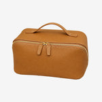 Cuirae brown pebbled genuine leather makeup bag with top handle and gold zipper, front angled view on white background