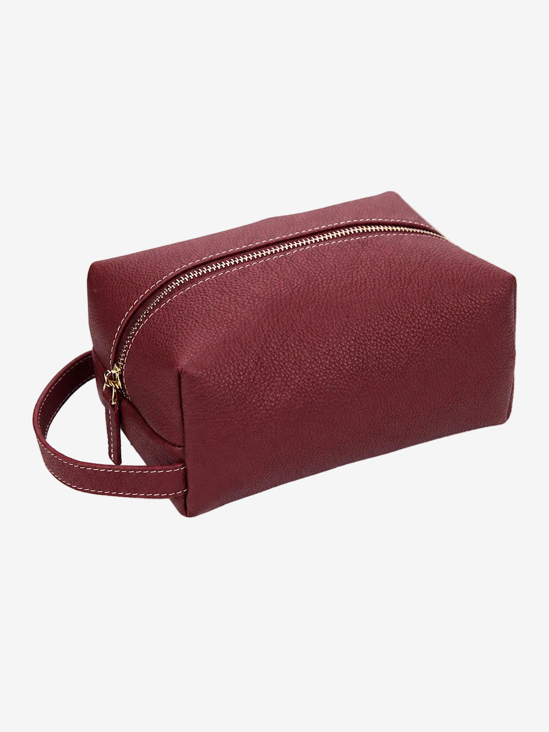 Cuirae burgundy pebbled genuine leather makeup bag with gold zipper and wrist strap, front angled view on white background