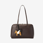 Cuirae chocolate brown genuine leather bowling shoulder bag with pony charm, front view showing smooth leather texture
