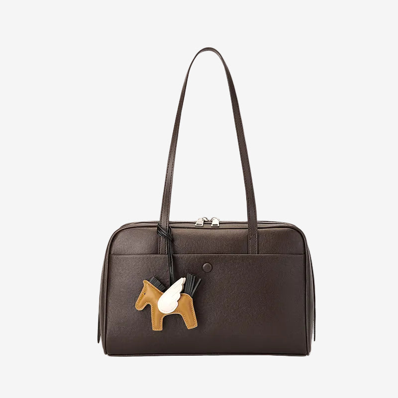 Cuirae chocolate brown genuine leather bowling shoulder bag with pony charm, front view showing smooth leather texture