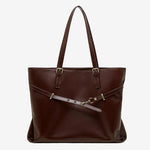 A front view of the Cuirae chocolate genuine leather tote bag standing on a plain background. 