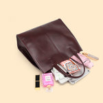 The Cuirae coffe genuine leather tote bag with various items 
