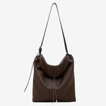 A front view of the Cuirae coffee genuine leather tote bag standing on a plain background.